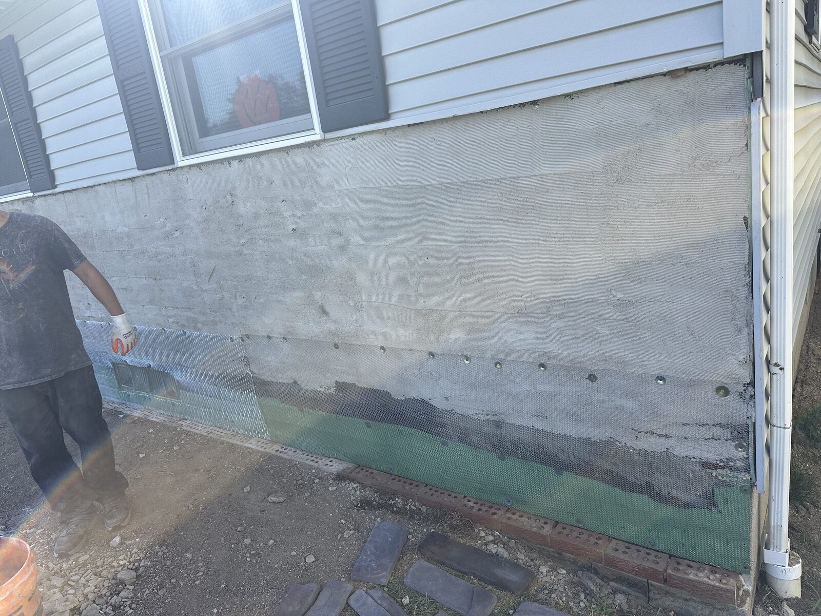 Concrete foundation wall prepared along the base of a house